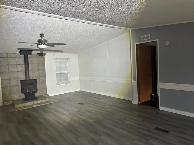 a view of a livingroom with wooden floor and a ceiling fan
