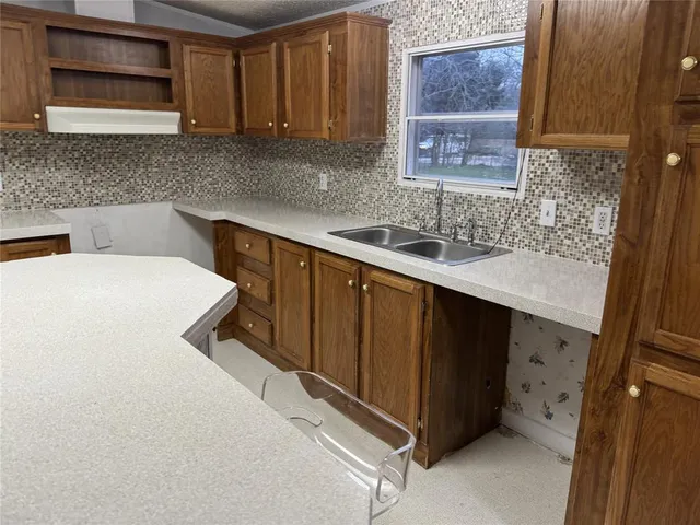 a kitchen with a sink a stove and cabinets