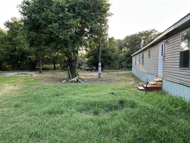 a view of a backyard with sitting area