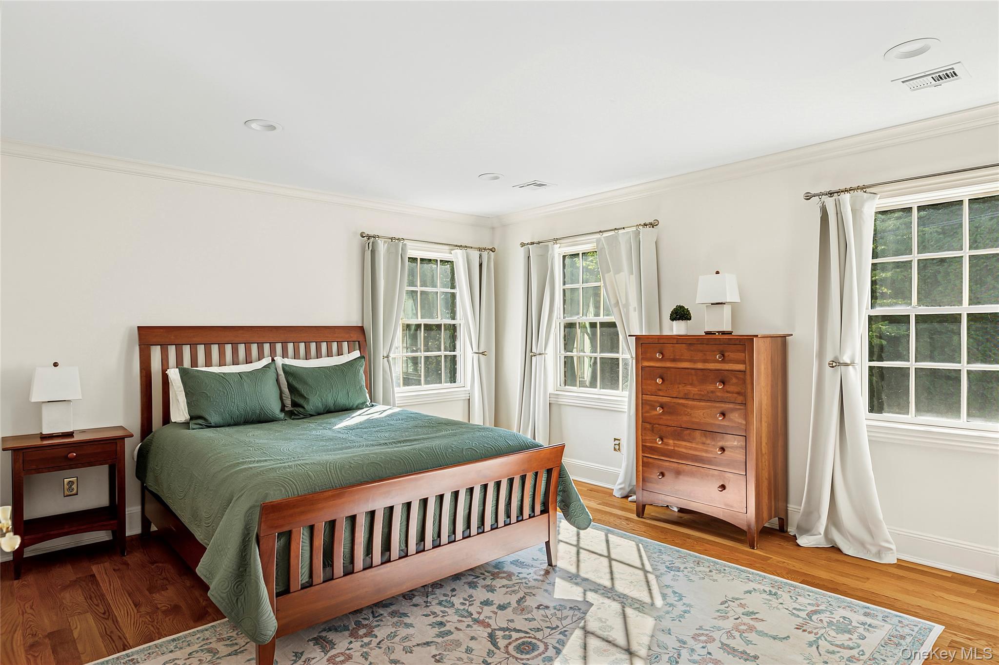 1270 Plandome Road Manhasset, NY 11030 - Photo 13 of 23 a bedroom with a bed closet and a window