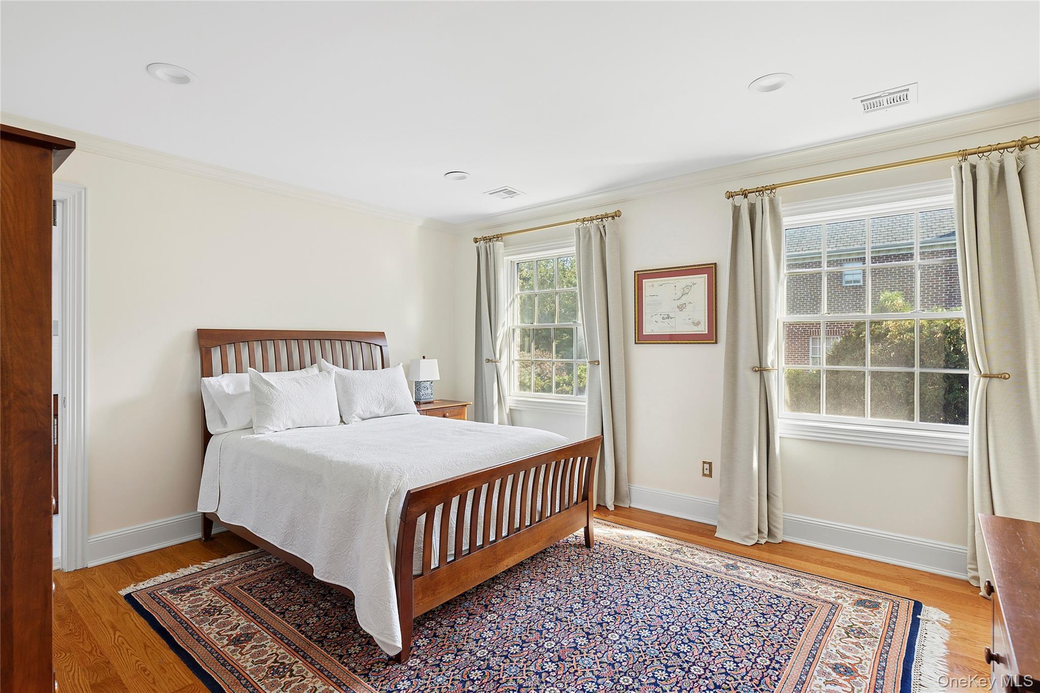1270 Plandome Road Manhasset, NY 11030 - Photo 15 of 23 a bedroom with a bed lamp and a window