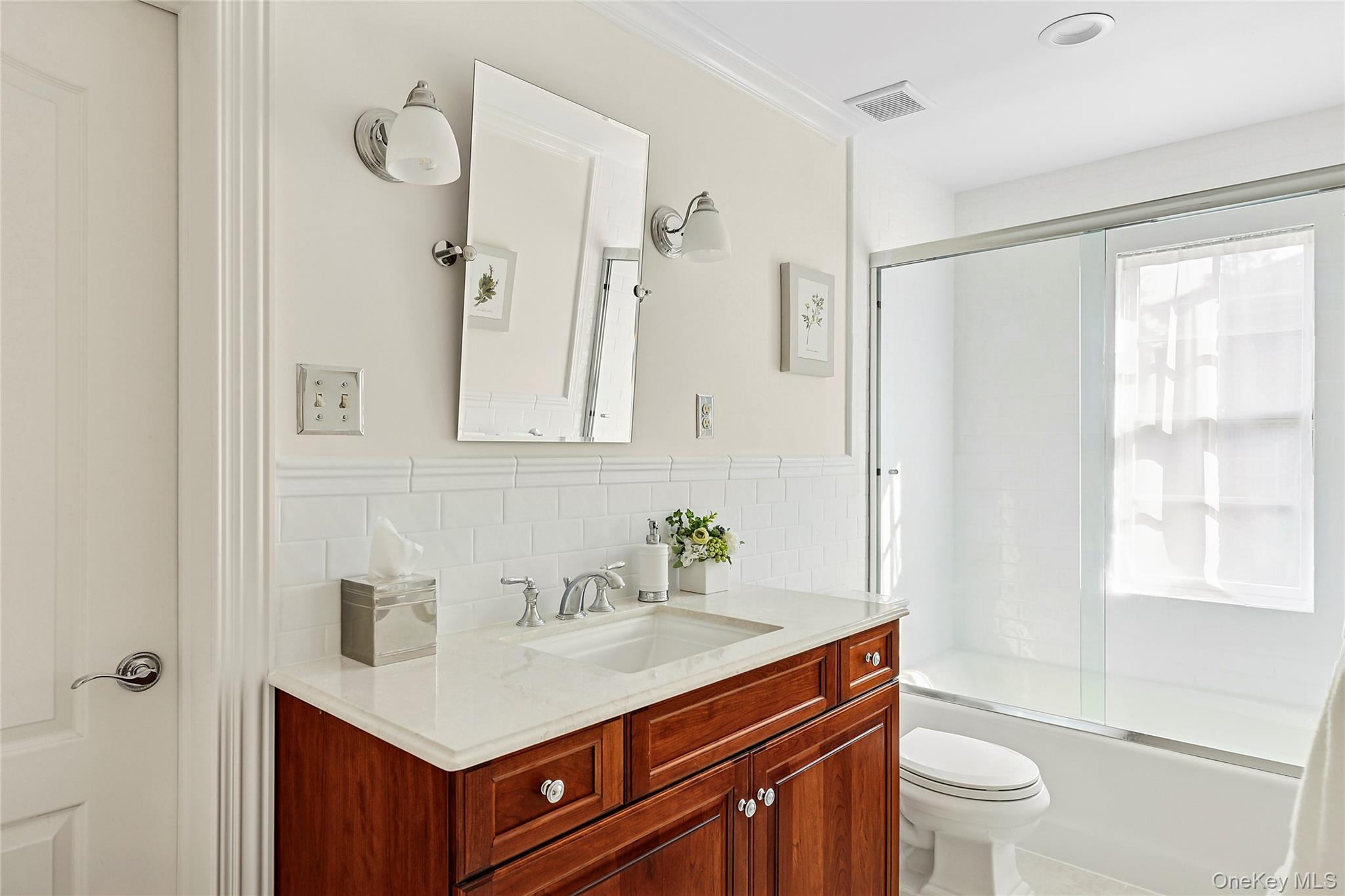 1270 Plandome Road Manhasset, NY 11030 - Photo 16 of 23 a bathroom with a sink toilet a mirror and shower
