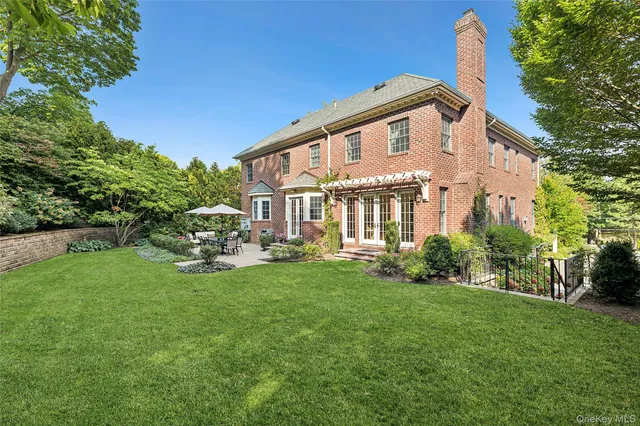 a view of a house with backyard sitting area and garden