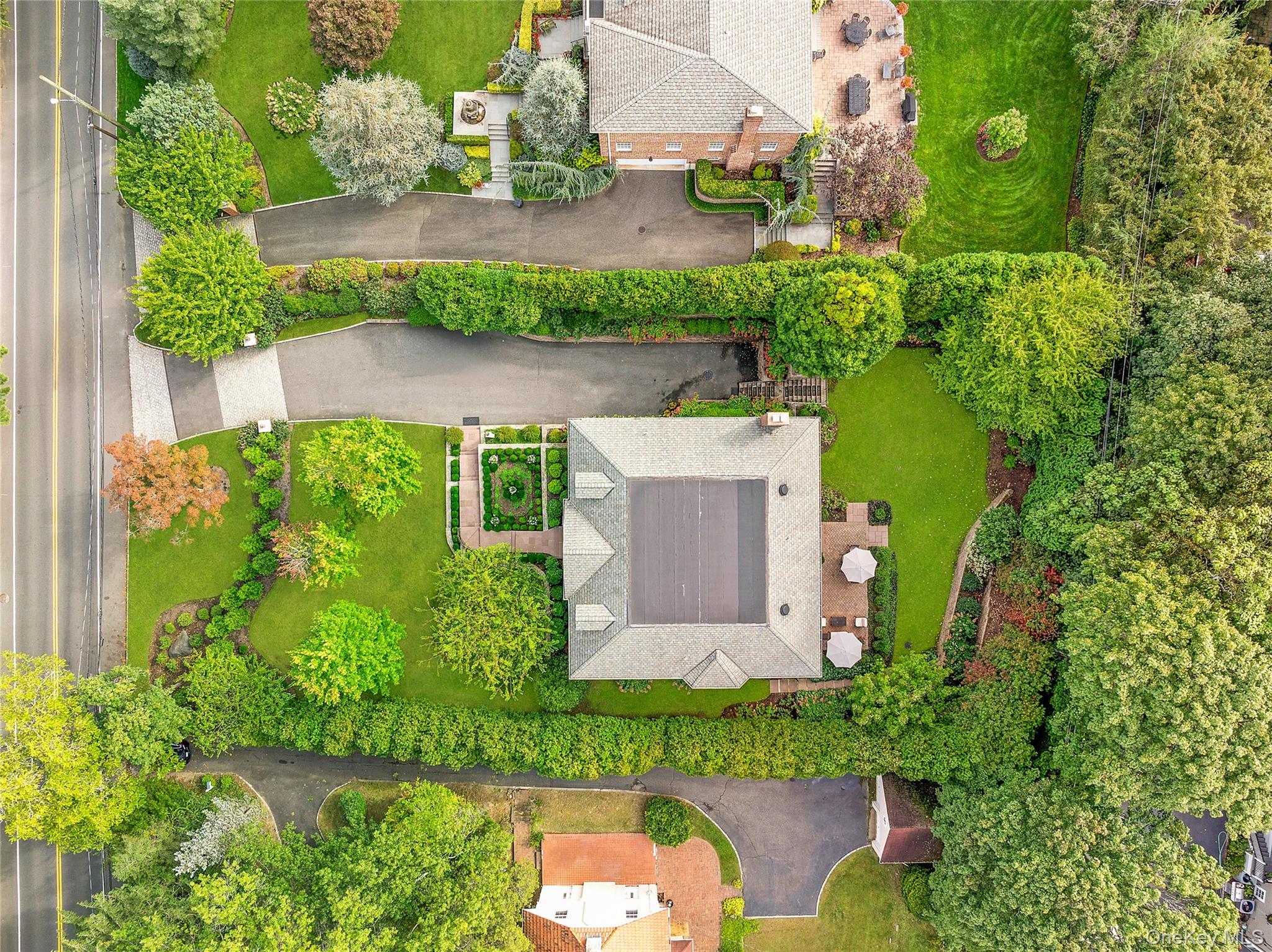 1270 Plandome Road Manhasset, NY 11030 - Photo 23 of 23 an aerial view of a house with a yard