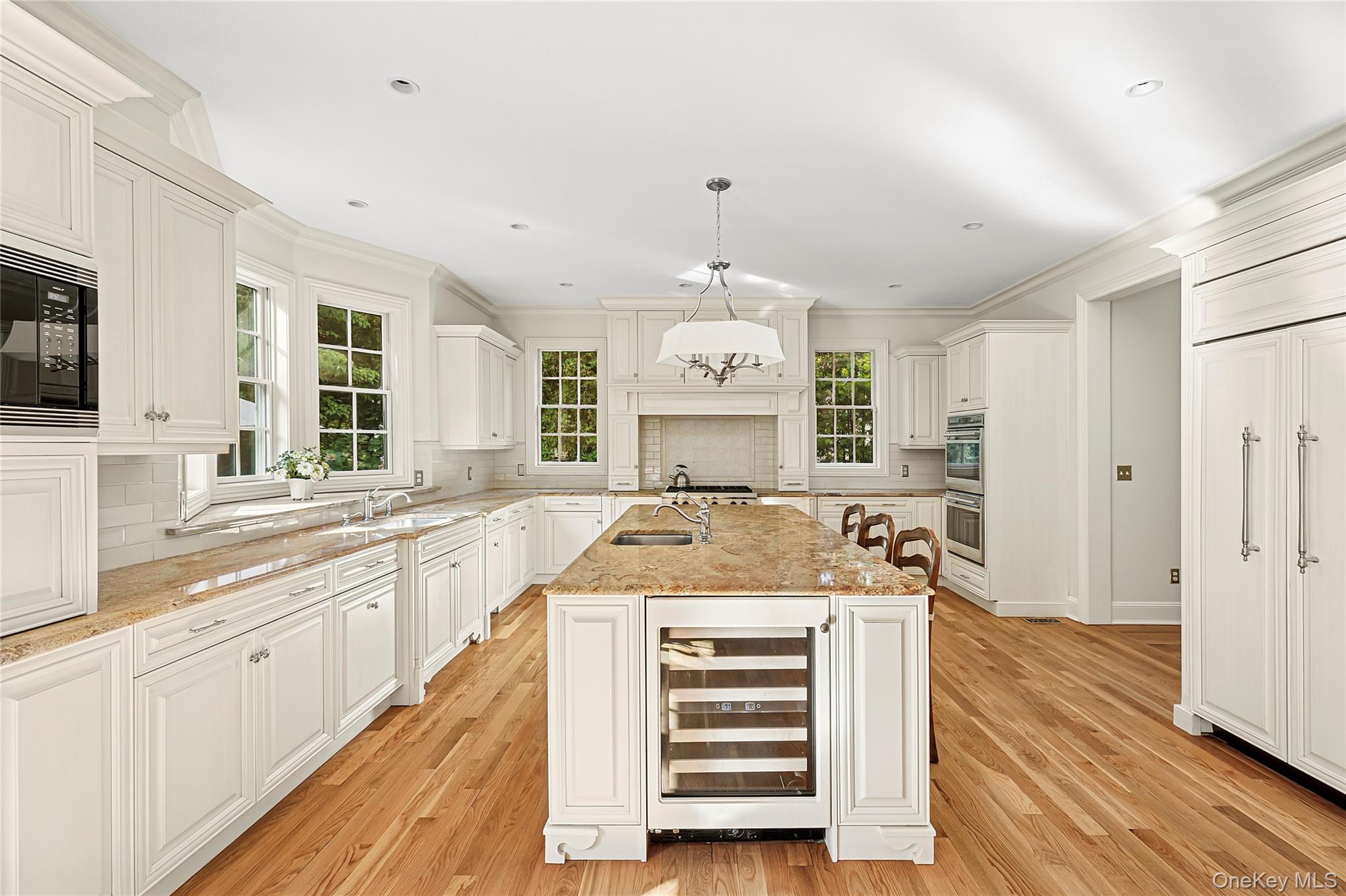 1270 Plandome Road Manhasset, NY 11030 - Photo 7 of 23 a large kitchen with a stove and a sink