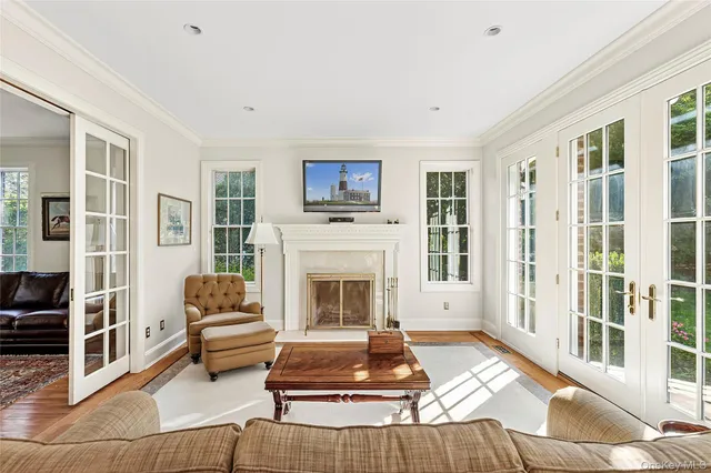 a living room with furniture a flat screen tv and a fireplace