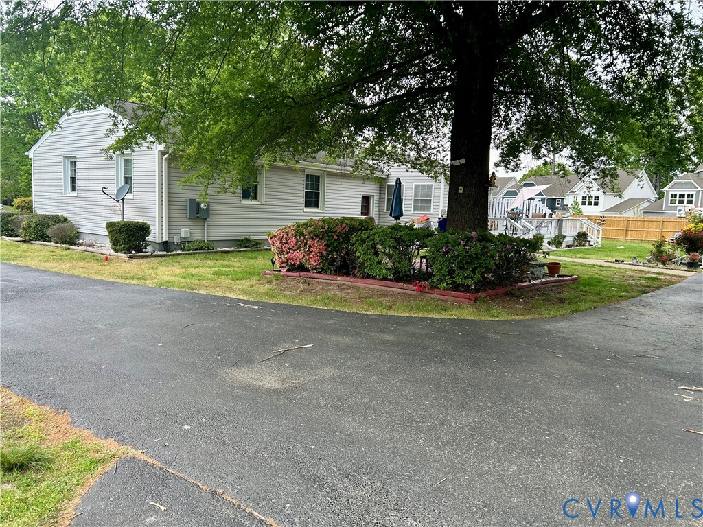 8054 Shady Grove Road Mechanicsville, VA 23111 - Photo 2 of 16 a front view of a house with a yard and garage