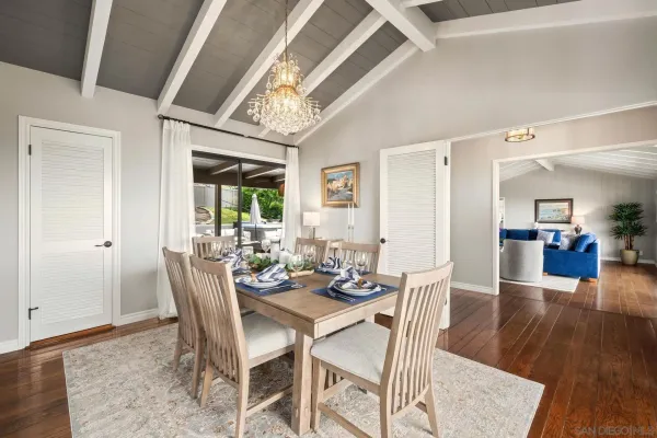 a dining room with furniture a chandelier and window