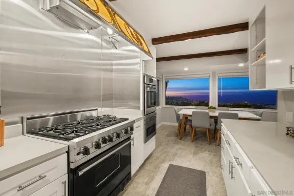 a bathroom with a granite countertop double vanity and a mirror