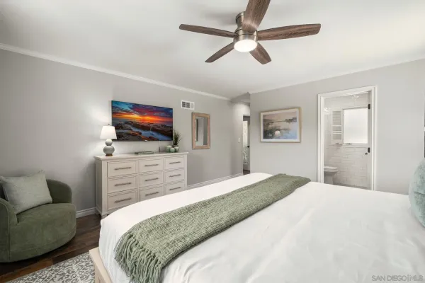 a view of a hallway with a white walls and wooden floor