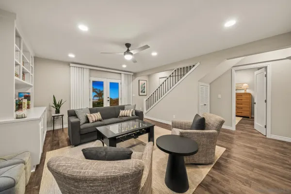 a view of a patio with couches table and chairs and potted plants