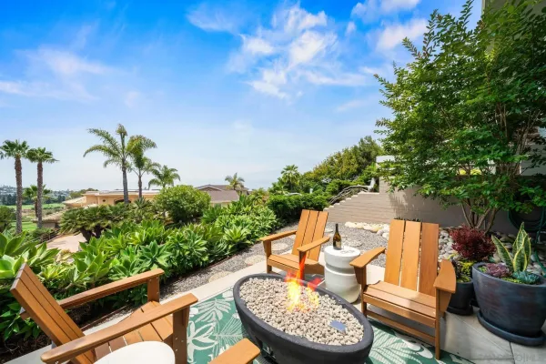 a view of a patio with chairs and potted plants