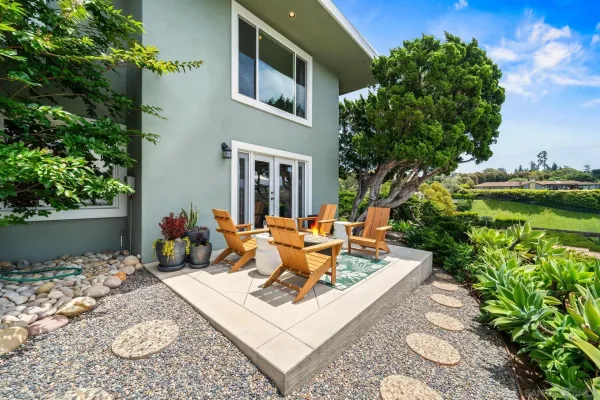 a front view of a house with plants