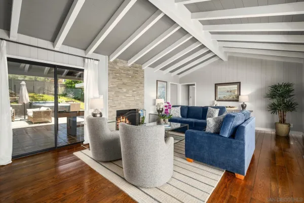 a living room with furniture and a floor to ceiling window