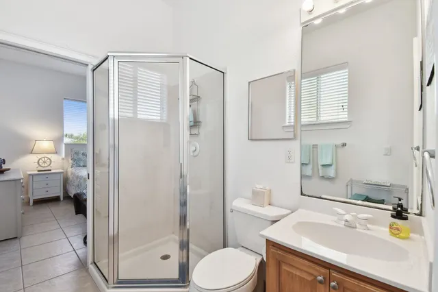 a bathroom with a toilet a sink and a mirror