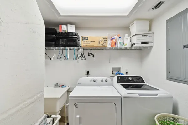 a living room with furniture a flat screen tv and white walls