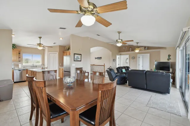 a large kitchen with stainless steel appliances granite countertop a sink refrigerator and microwave