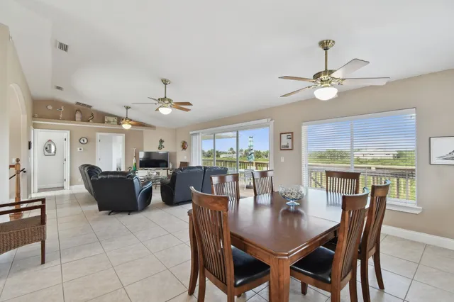 a kitchen with a table chairs sink and cabinets