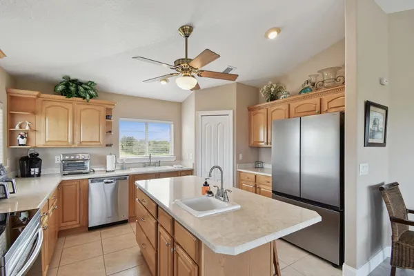 a kitchen with a stove a sink a dining table and chairs