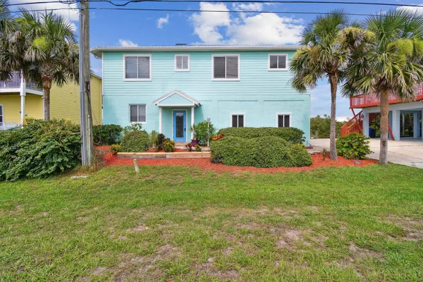 a front view of house with yard and green space