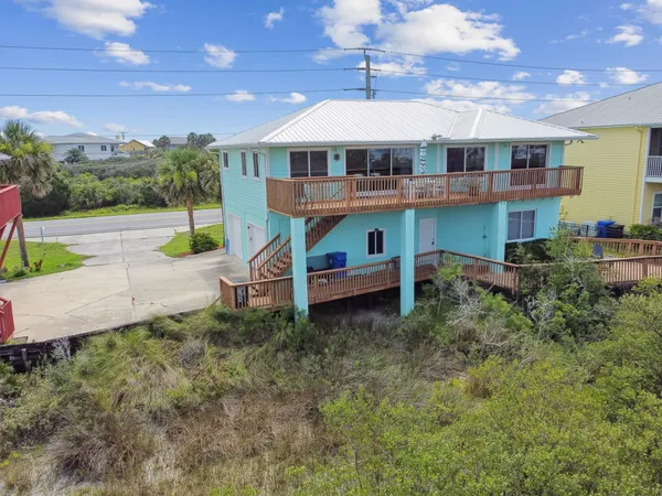an aerial view of a house with garden space and street view
