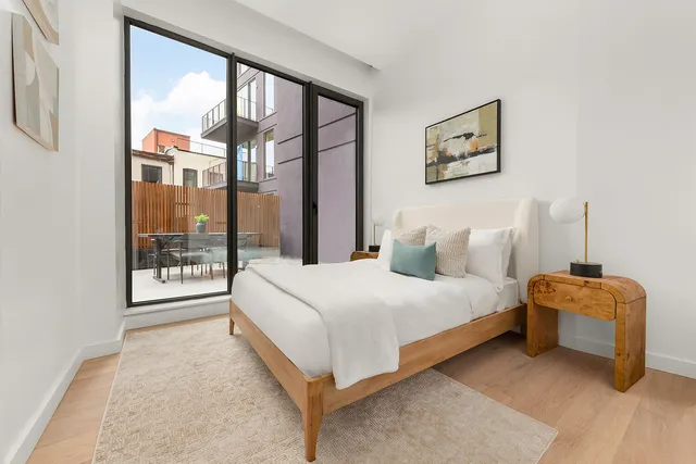 a bedroom with a large bed and a window