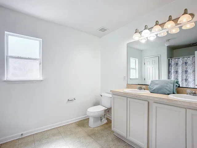 a view of a bathroom with a shower and a sink