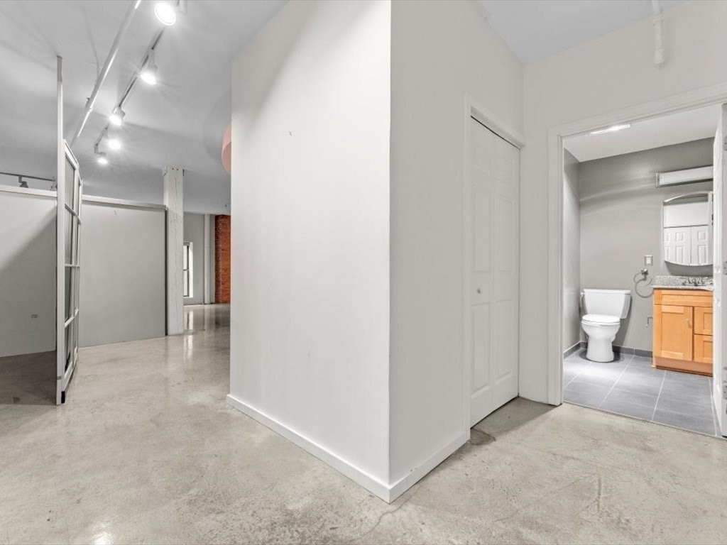 172 Middle Street, Unit 304 Lowell, MA 01852 - Photo 22 of 31 a view of a livingroom and a bathroom