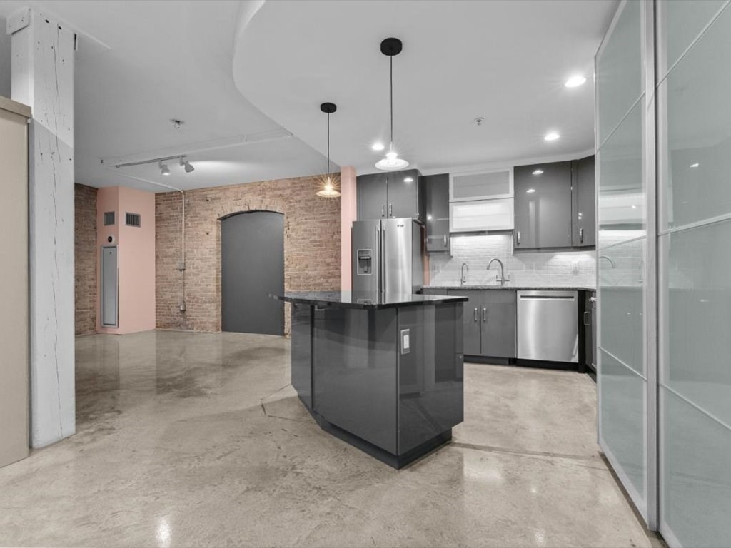 172 Middle Street, Unit 304 Lowell, MA 01852 - Photo 7 of 31 a kitchen with stainless steel appliances granite countertop a sink a counter space and cabinets