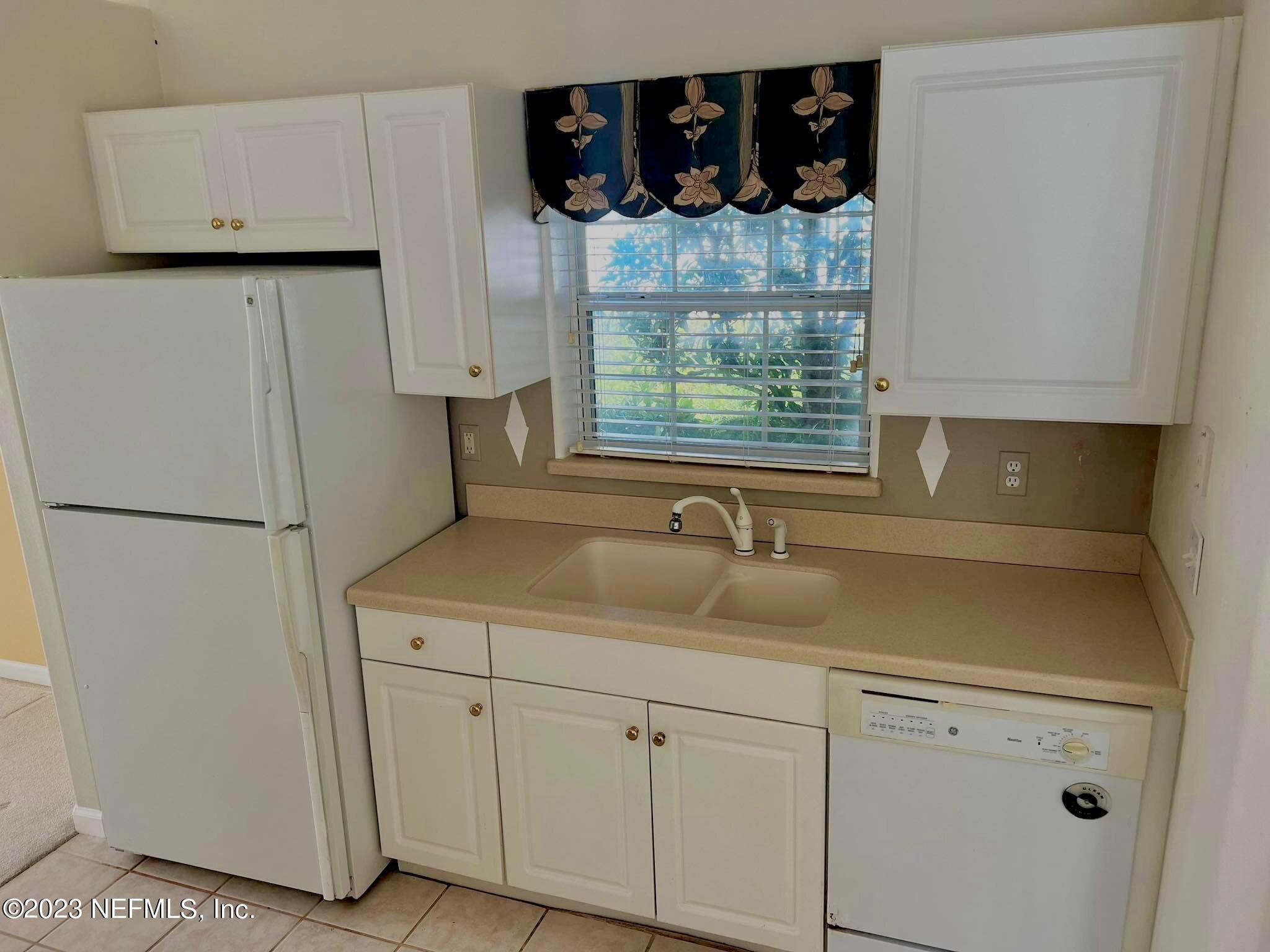 117 Cedar Ridge Circle St. Augustine, FL 32080 - Photo 3 of 27 a kitchen with white cabinets and a sink