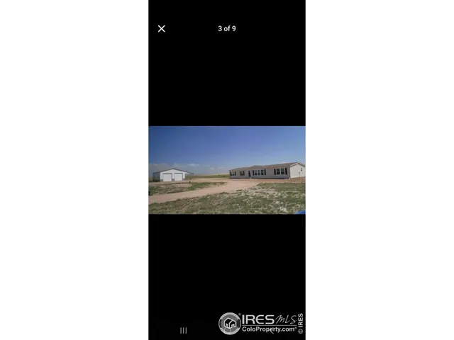 a view of a living room with a black and white wall