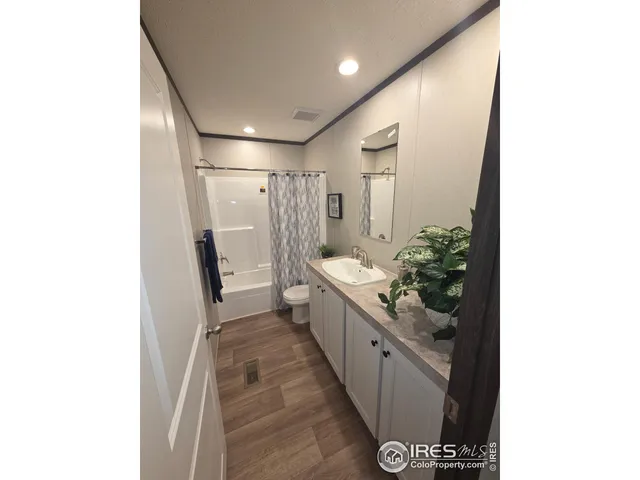 a large bathroom with a sink and a large mirror