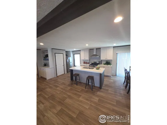 a kitchen with a dining table chairs and a refrigerator