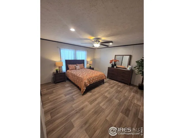 a bedroom with a bed and a night stand