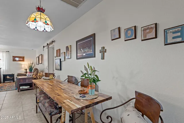 a view of a dining room with furniture a chandelier and wooden floor