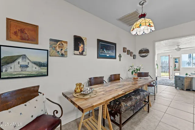 a view of a workspace with furniture and a chandelier fan