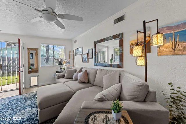 a living room with furniture and a glass door