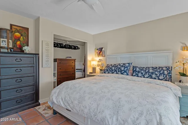 a large bed sitting in a bedroom and dresser