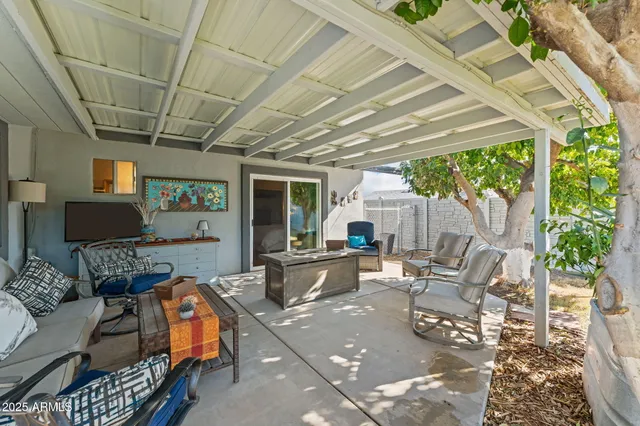 a view of a house with backyard sitting area and porch