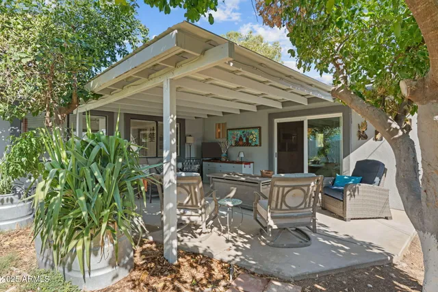 a view of a house with backyard and sitting area