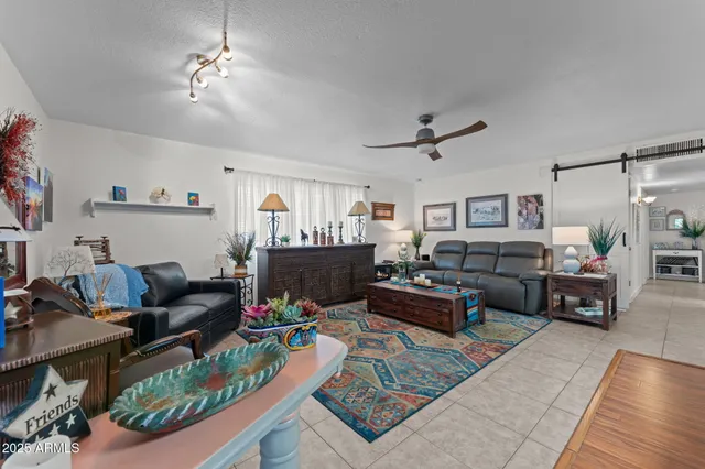 a living room with furniture and a wooden floor