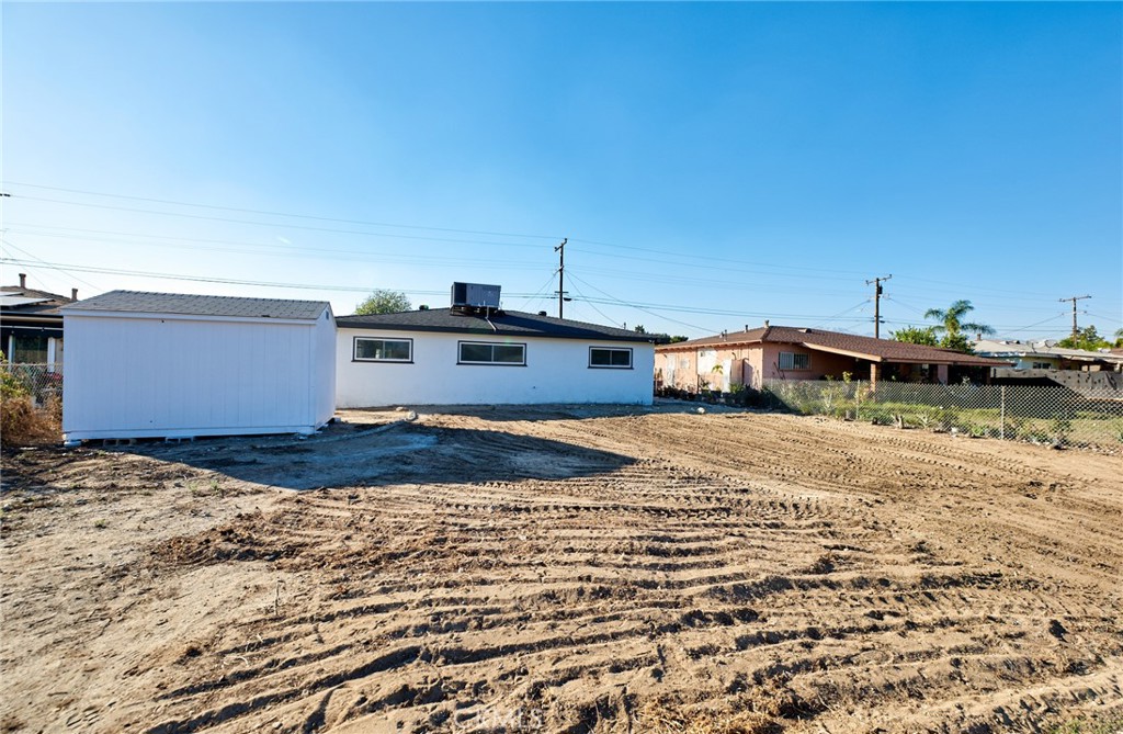 9871 Magnolia Street Bloomington, CA 92316 - Photo 16 of 16 a front view of a house with a yard