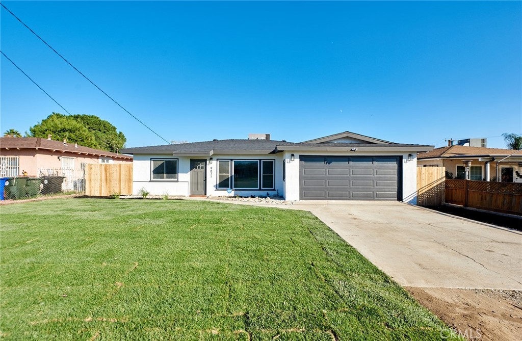9871 Magnolia Street Bloomington, CA 92316 - Photo 3 of 16 a front view of a house with a garden