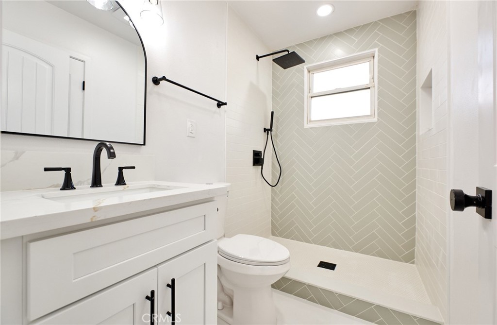 9871 Magnolia Street Bloomington, CA 92316 - Photo 8 of 16 a bathroom with a sink a toilet and shower