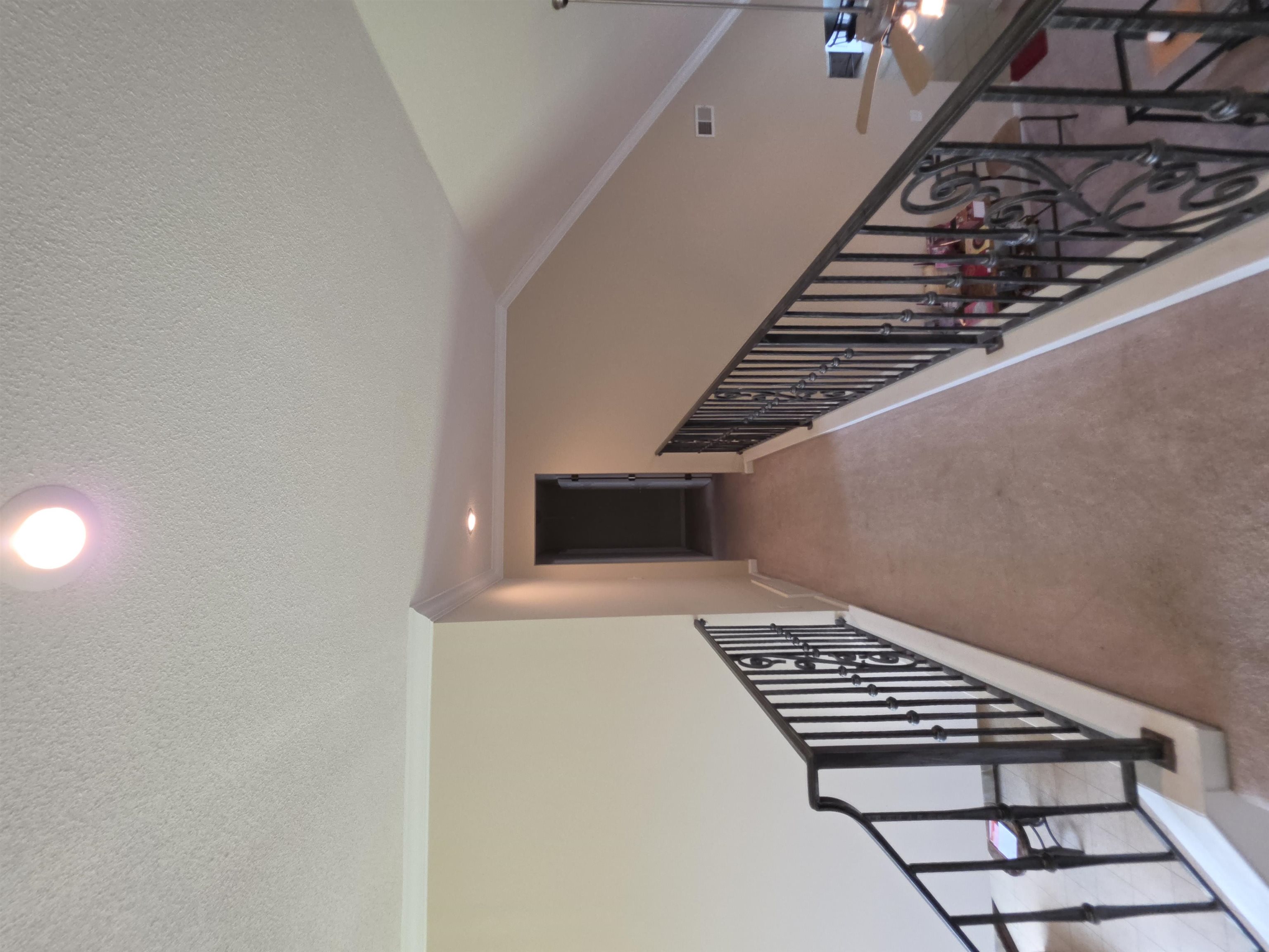 7253 Rourke Circle Memphis, TN 38125 - Photo 21 of 31 Open hallway featuring decorative wrought iron railings, vaulted ceiling, recessed lighting, and carpeted flooring