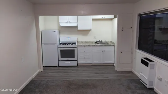 a kitchen with stainless steel appliances granite countertop a stove and a microwave