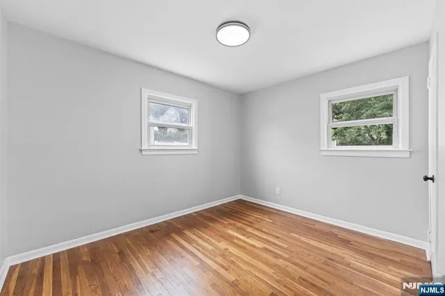 a view of room with window and wooden floor