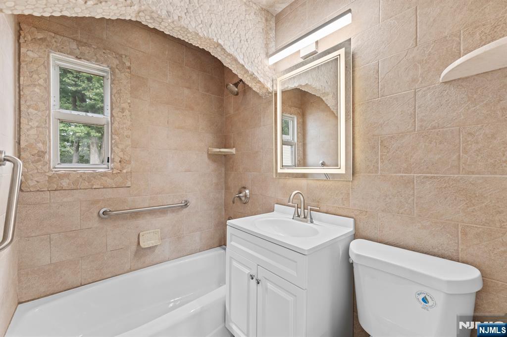 18 Farmingdale Avenue Bloomfield, NJ 07003 - Photo 21 of 50 a bathroom with a sink toilet and vanity