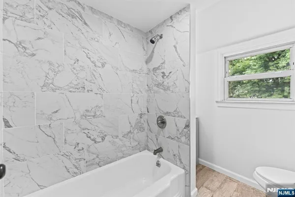 a bathroom with a bathtub and shower