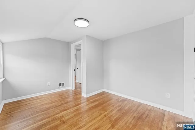a view of room with wooden floor